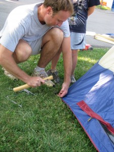 Daddy pitching the tent.